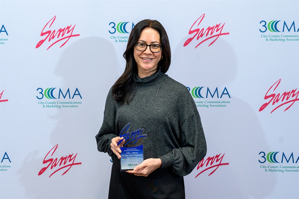 Communications Manager Vic Hathaway holding 2025 3CMA award