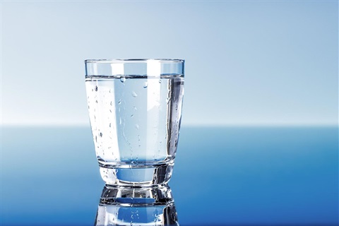 Glass of water with blue background