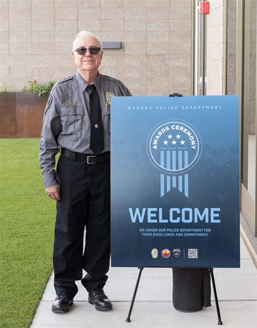 Volunteer with the Welcome sign