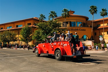 Mayor and Council in Founders Day Parade in red vintage fire truck