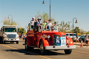 Mayor Post and Town Council wave to parade attendees 