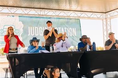 Teri Murphy announcing parade with judges