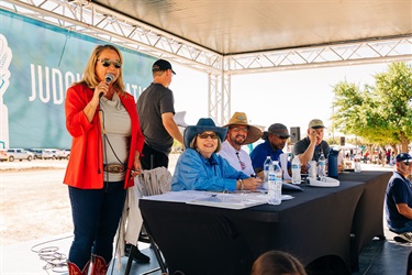 Councilmember Teri Murphy announcing the parade next to judges