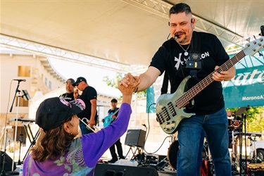 Xplosion shaking hands with community member
