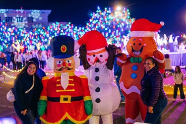 Attendees posing with inflatable characters at night