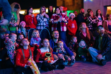 Families smiling during tree lighting show