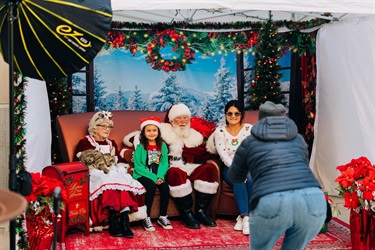 Family poses for photos with Mr and Mrs Claus