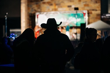 Man with a cowboy hat in front of Santa's Stage