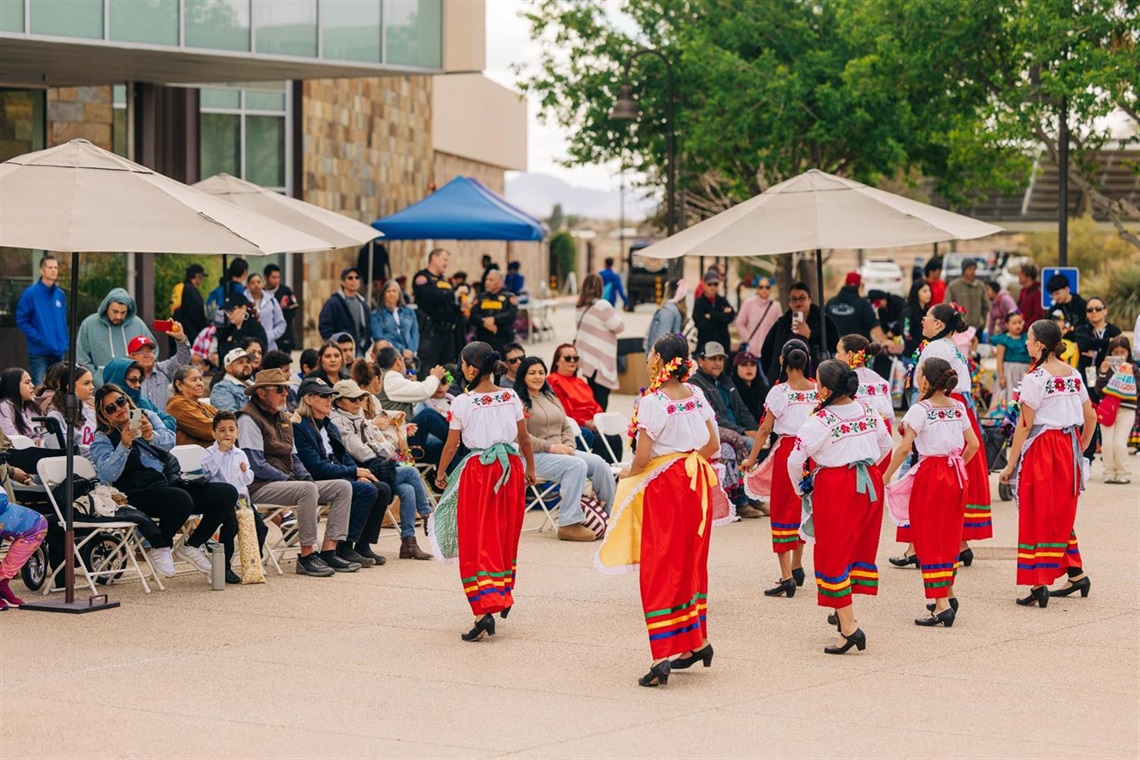 Marana Founders day performers with umbrellas as shade