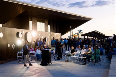 Wide view of art unveiling crowd