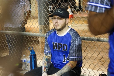 MPD player resting on the bench during softball game
