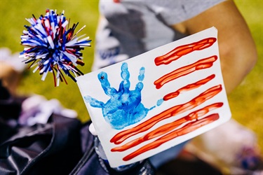 American flag painting with child's hand