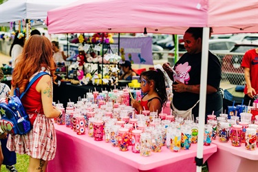 Guest standing at pink vendor during event