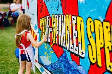 Little girl paints Star-Spangled Spectacular public mural