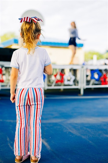 Little girl watches the Manhattan Dolls perform