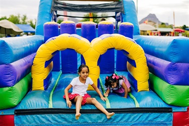 Two kids on giant inflatable 