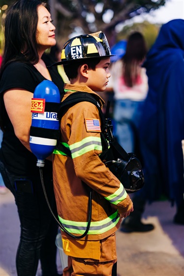 Kid dressed up as a firefighter